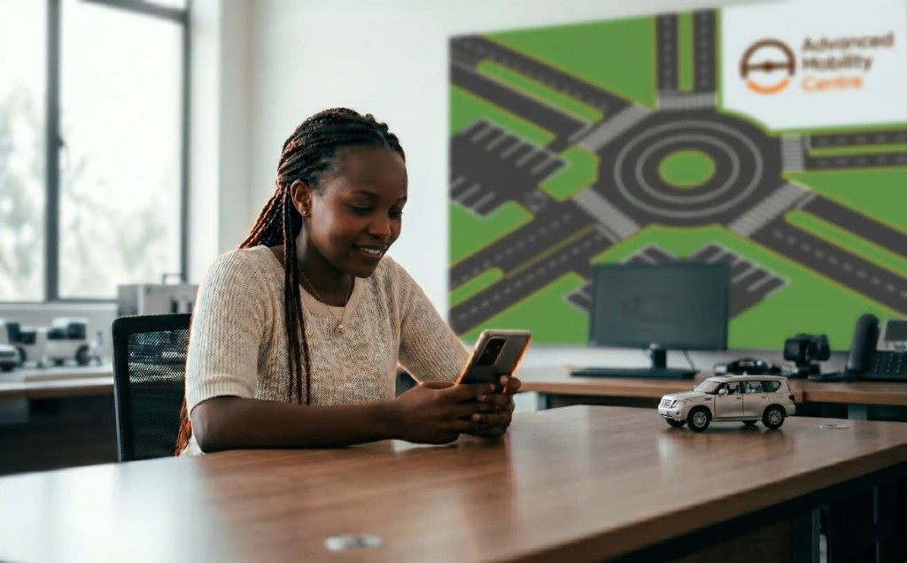 Learner at Advanced Mobility Centre studying on a smartphone at a training desk